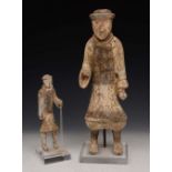 A CHINESE POTTERY TOMB FIGURE, male subject with outstretched arm, 56cm high; together with 'A
