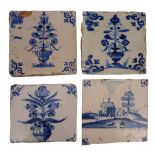 A GROUP OF FOUR ANTIQUE DELFT BLUE AND WHITE POTTERY TILES with varying decoration, approximately