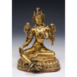 AN OLD NEPALESE BRASS SEATED BHUDDA on a shaped base, 18cm high