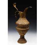 A LARGE EMBOSSED GILT BRASS EWER, perhaps Indian, decorated with lions, deer and a crescent moon