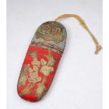 AN ANTIQUE CHINESE SILK AND METAL THREAD SPECTACLE CASE decorated with flowers on a blue and red