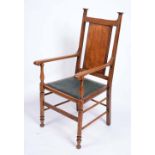 AN ARTS & CRAFTS OAK OPEN ARMCHAIR with panelled back, studded upholstered seat and shaped arms,