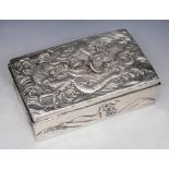 A CHINESE RECTANGULAR SHAPED CIGARETTE BOX chased with a dragon in relief and waves on the sides,