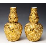 A PAIR OF ROYAL CROWN DERBY VASES, the ivory ground with a blue glazed trellis design deavily gilt