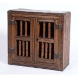 AN ANTIQUE OAK FOOD HUTCH with one shelf enclosed by two doors with ring turned slats and metal