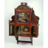 A LATE VICTORIAN WALNUT WALL CABINET, having domed top above a glazed door depicting figures in a