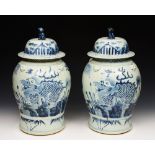 A PAIR OF CHINESE PORCELAIN BLUE AND WHITE BALUSTER VASES, each with cover and kylin finial, 50cm
