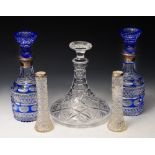 A PAIR OF BLUE OVERLAID CUT GLASS DECANTERS AND STOPPERS, with silver mounts, 30cm high; a cut glass