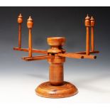 A 19TH CENTURY TREEN WOOL WINDER on turned base, 27cm high