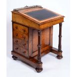 A MID VICTORIAN FIGURED WALNUT DAVENPORT, the hinged leather inset top enclosed fitted maple