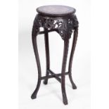 A CHINESE HARDWOOD URN STAND with inset marble top, carved decoration and splay legs, 76cm high