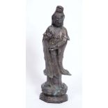 A LARGE CHINESE BRONZE FIGURE of Quan Yin with flowing robes and on a naturalistic base, 97cm high