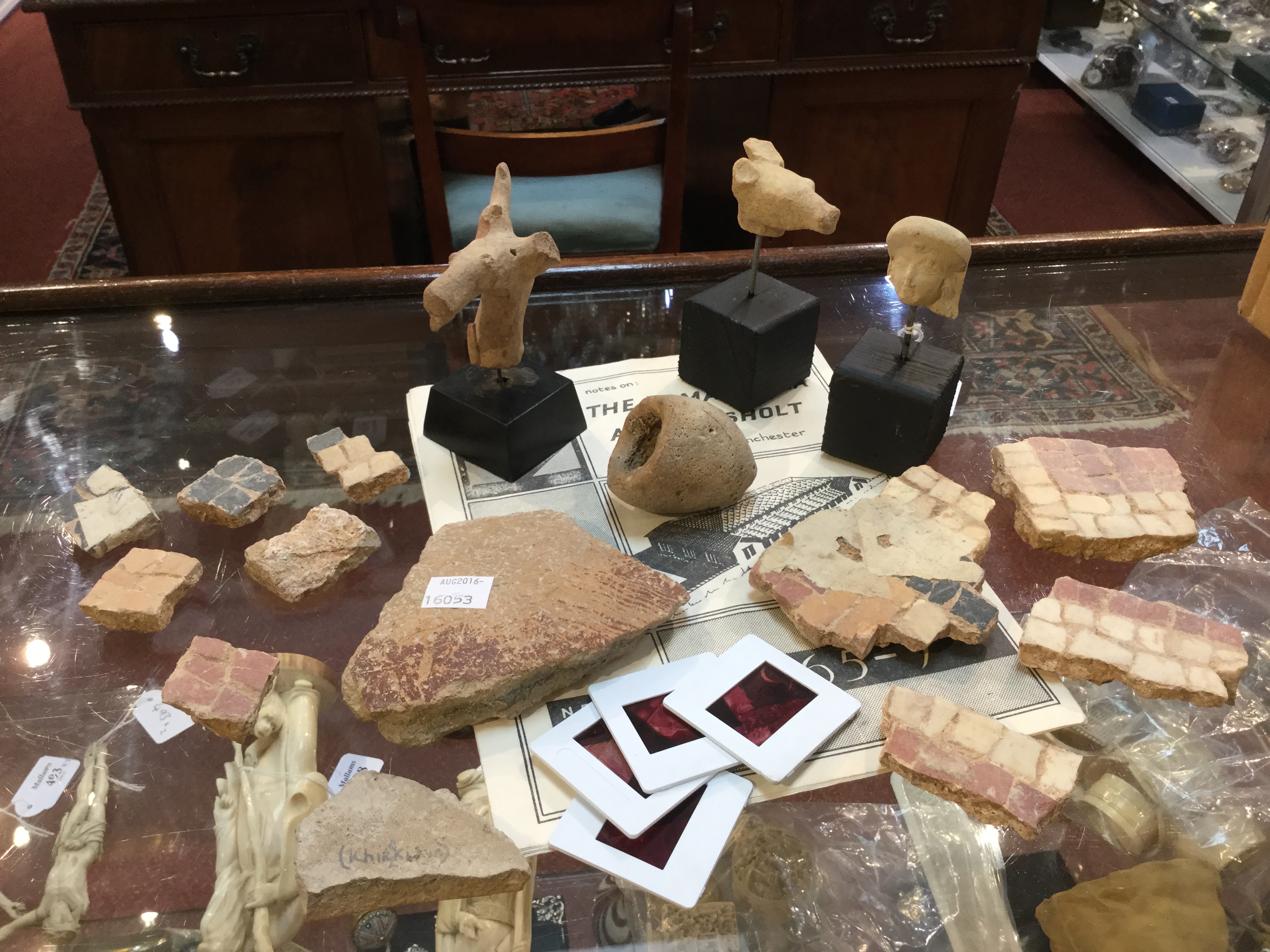 A MISCELLANEOUS COLLECTION OF ANTIQUITIES including mosaic and terracotta fragments, Roman and