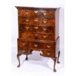 AN 18TH CENTURY WALNUT VENEERED CHEST ON STAND fitted an arrangement of four long and five deep