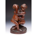 AN EASTERN CARVED FIGURE GROUP in the form of two natives wrestling, incised with name to the