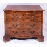 A GEORGE III MAHOGANY SERPENTINE CHEST of four long graduated drawers with brushing slide and