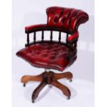 A 20TH CENTURY RED LEATHER SWIVEL LIBRARY CHAIR with beaded and buttoned upholstery, 58cm wide