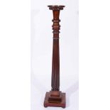 A MAHOGANY TORCHERE of turned and fluted form on a square stepped base, 138cm high