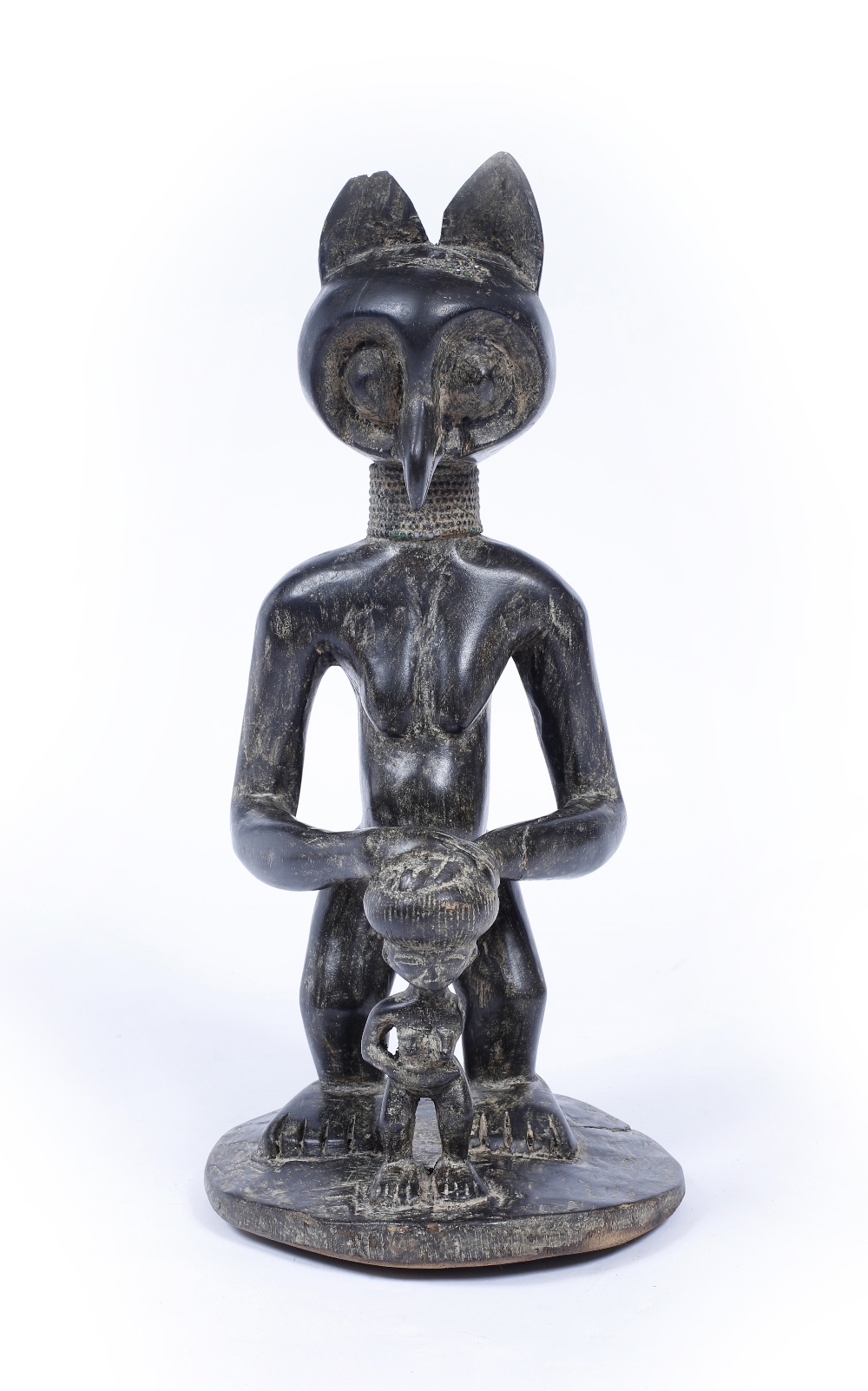 AN ANGOLA, CHOCKWE TRIBE, CARVED BLACKWOOD OWL FIGURE with child representing the owl as a wise