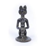 AN ANGOLA, CHOCKWE TRIBE, CARVED BLACKWOOD OWL FIGURE with child representing the owl as a wise
