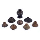 A COLLECTION OF FIVE POTTERY SPINDLE WEIGHTS, two larger wooden examples with carved decoration, 6cm