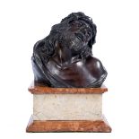 AN ITALIAN BRONZE BUST after the Antique 'Christ of Sorrows' on a rouge marble rectangular plinth,