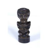 A CARVED STONE HALF FROG HALF HUMAN FIGURE with webbed hands and on circular base, 15cm high