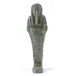 AN EARLY EGYPTIAN GREEN FAIENCE GLAZED SHABTI OR FUNERARY FIGURE decorated with hieroglyphic script,