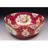 A 19TH CENTURY STAFFORDSHIRE PORCELAIN CIRCULAR BOWL with painted summer flower decoration on a dark