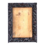 AN ANTIQUE GERMAN RECTANGULAR CARVED WALNUT PICTURE FRAME with hunting trophy motif, 61 x 46cm