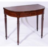 A GEORGE IV MAHOGANY AND ROSEWOOD CROSSBANDED 'D' SHAPED FOLD OVER CARD TABLE on ring turned legs,