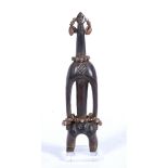 AN AFRICAN CARVED WOODEN FIGURE of elongated form with beaded ornament, 36cm high