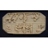 AN ANTIQUE CARVED IVORY PANEL, probably a box lid decorated dancing figures, 9 x 4.5cm, preserved in