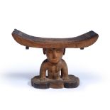 A RHODESIAN, SHONA TRIBE CARVED WOODEN HEAD REST female torso support on a shaped base, 20.5cm