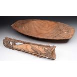 A SOUTH EAST ASIAN CARVED WOODEN BOWL with scroll handles, 67cm long; together with a fish container