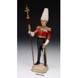 A SITZENDORF FIGURE of a soldier or guard on gilt heightened base, 31cm high