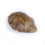 A PALAEOLITHIC BROWN FLINT STONE HAND AXE of natural form, 11.5cm