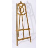 A 19TH CENTURY GILTWOOD ARTIST'S EASEL with carved lyre decoration, 183cm high