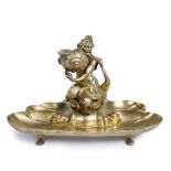 A REGENCY GILT BRONZE DESK STAND in the form of Triton on a sea creature and scallop shell, 26cm