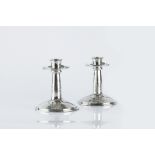 Liberty & Co. Pair of candlesticks, circa 1900 hammered pewter, cast with leaf design to the bases