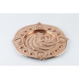 Newlyn School (attributed to) Wall charger hammered copper with griffin head to the centre 41cm