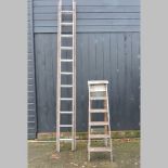 A wooden ladder, together with a wooden folding step ladder,