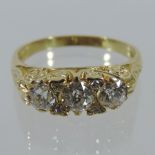 An 18 carat gold three stone diamond ring, approx. 1.