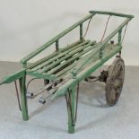 A green painted wooden coffin barrow,