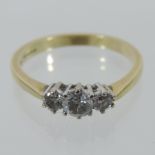 An 18 carat gold three stone diamond ring