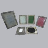 A collection of early 20th century and later silver and other photograph frames