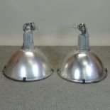 A pair of large industrial light fittings,