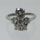 An early 20th century platinum and diamond dress ring, set with square and round cut diamonds,