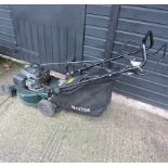 A green Hayter petrol lawnmower,