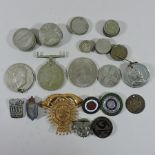 A collection of coins and badges,